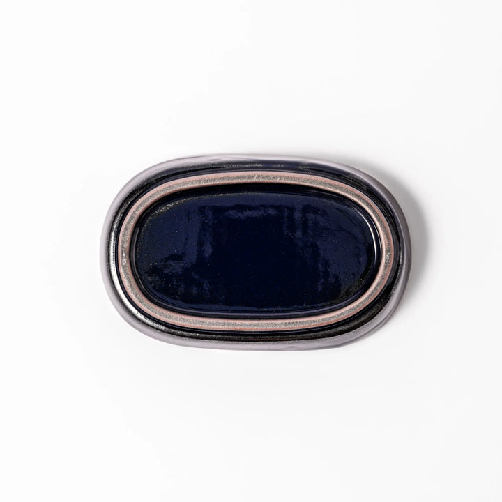 Deep blue ceramic ginger grater dish with raised teeth and a shallow base, designed for efficiently grating ginger, garlic, or daikon.
