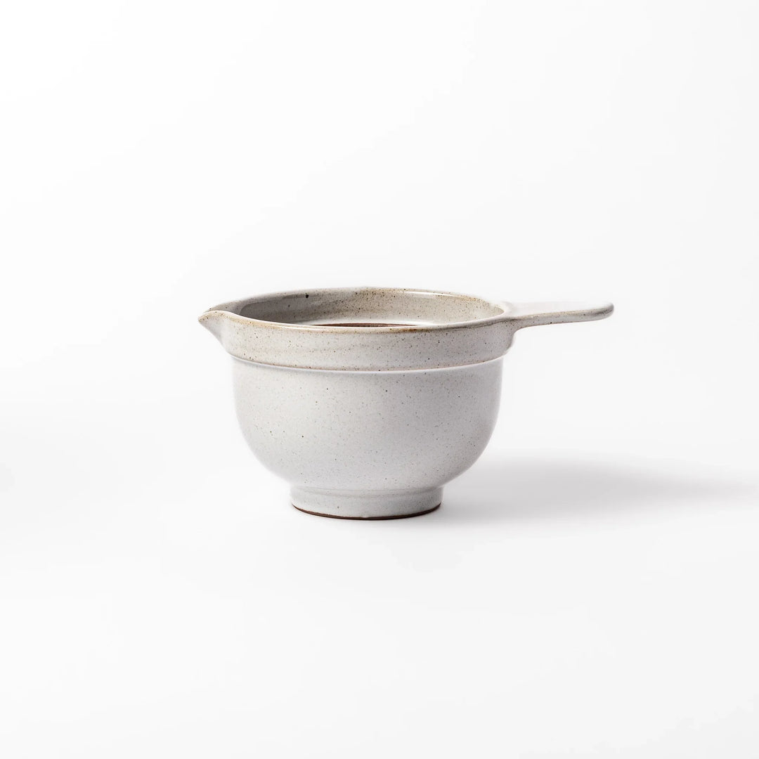 White ceramic natto suribachi bowl with a textured brown interior and side handle, ideal for grinding ingredients or mixing natto with control.