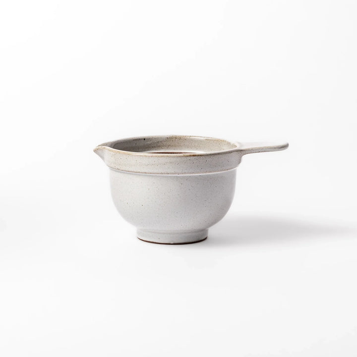 White ceramic natto suribachi bowl with a textured brown interior and side handle, ideal for grinding ingredients or mixing natto with control.