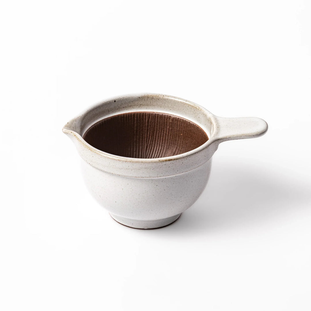 White ceramic natto suribachi bowl with a textured brown interior and side handle, ideal for grinding ingredients or mixing natto with control.