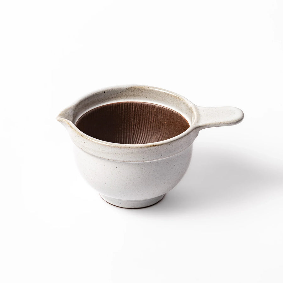 White ceramic natto suribachi bowl with a textured brown interior and side handle, ideal for grinding ingredients or mixing natto with control.