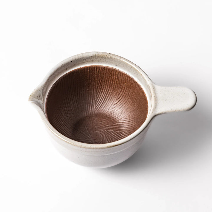 White ceramic natto suribachi bowl with a textured brown interior and side handle, ideal for grinding ingredients or mixing natto with control.