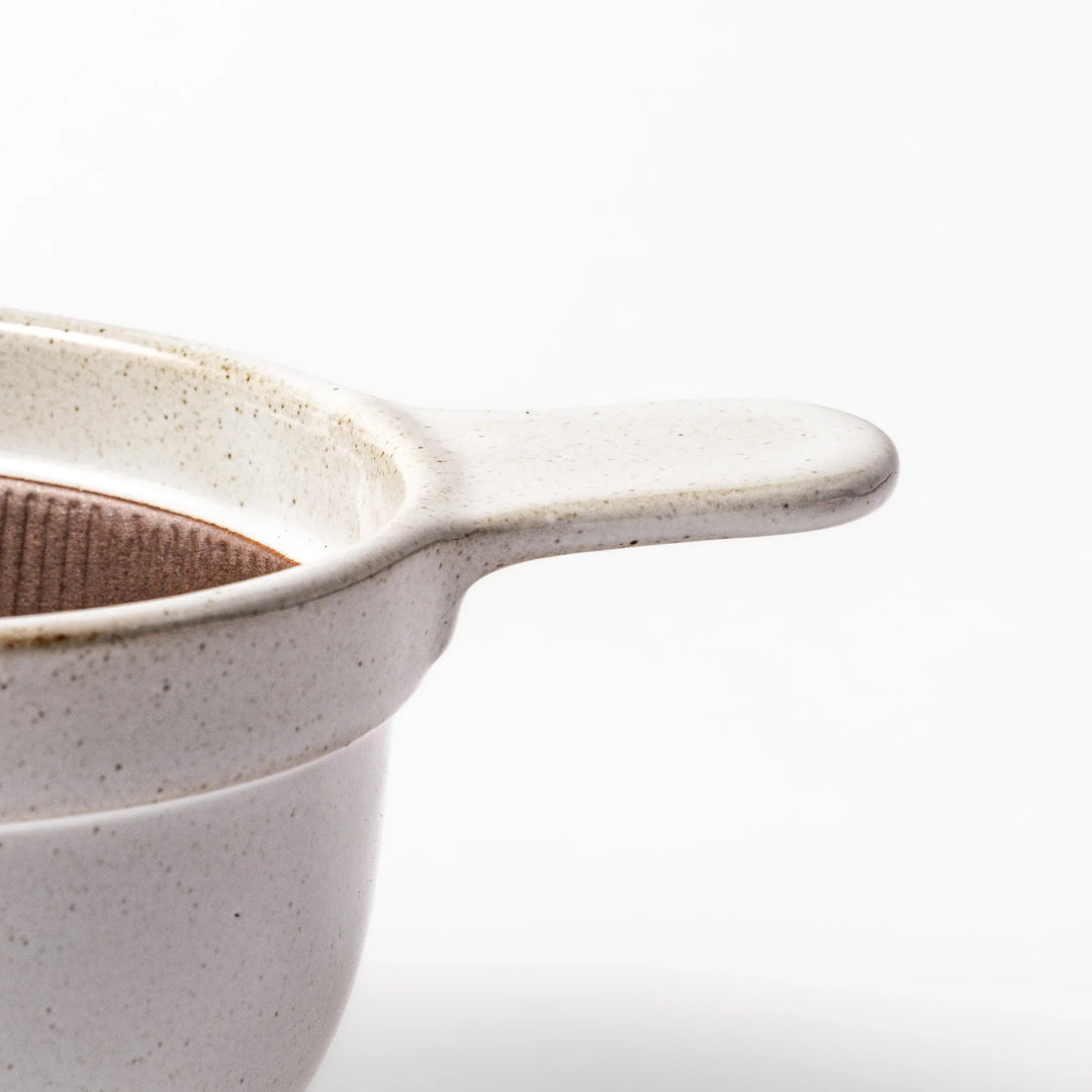 White ceramic natto suribachi bowl with a textured brown interior and side handle, ideal for grinding ingredients or mixing natto with control.