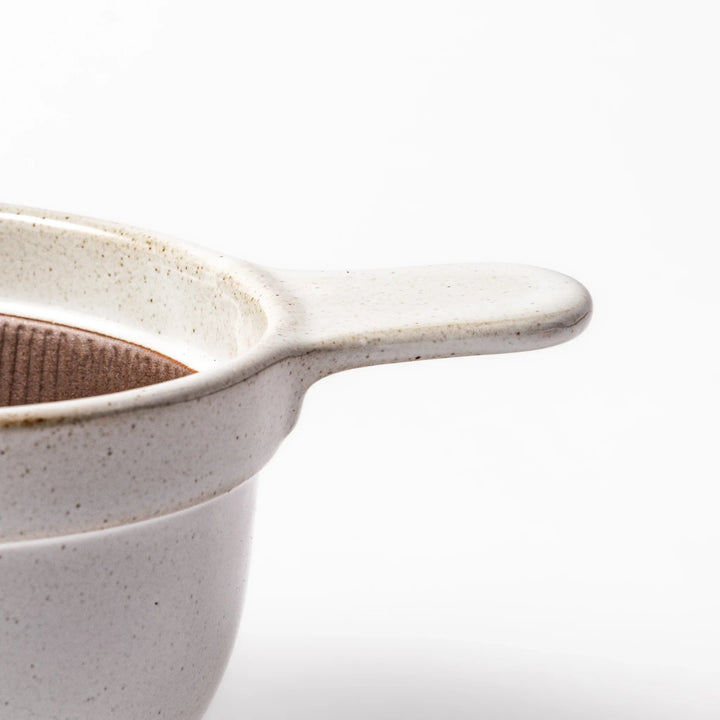 White ceramic natto suribachi bowl with a textured brown interior and side handle, ideal for grinding ingredients or mixing natto with control.