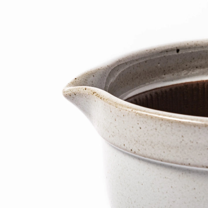 White ceramic natto suribachi bowl with a textured brown interior and side handle, ideal for grinding ingredients or mixing natto with control.