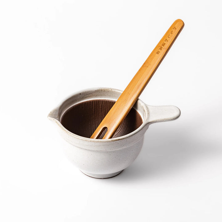White ceramic natto suribachi bowl with a textured brown interior and side handle, ideal for grinding ingredients or mixing natto with control.