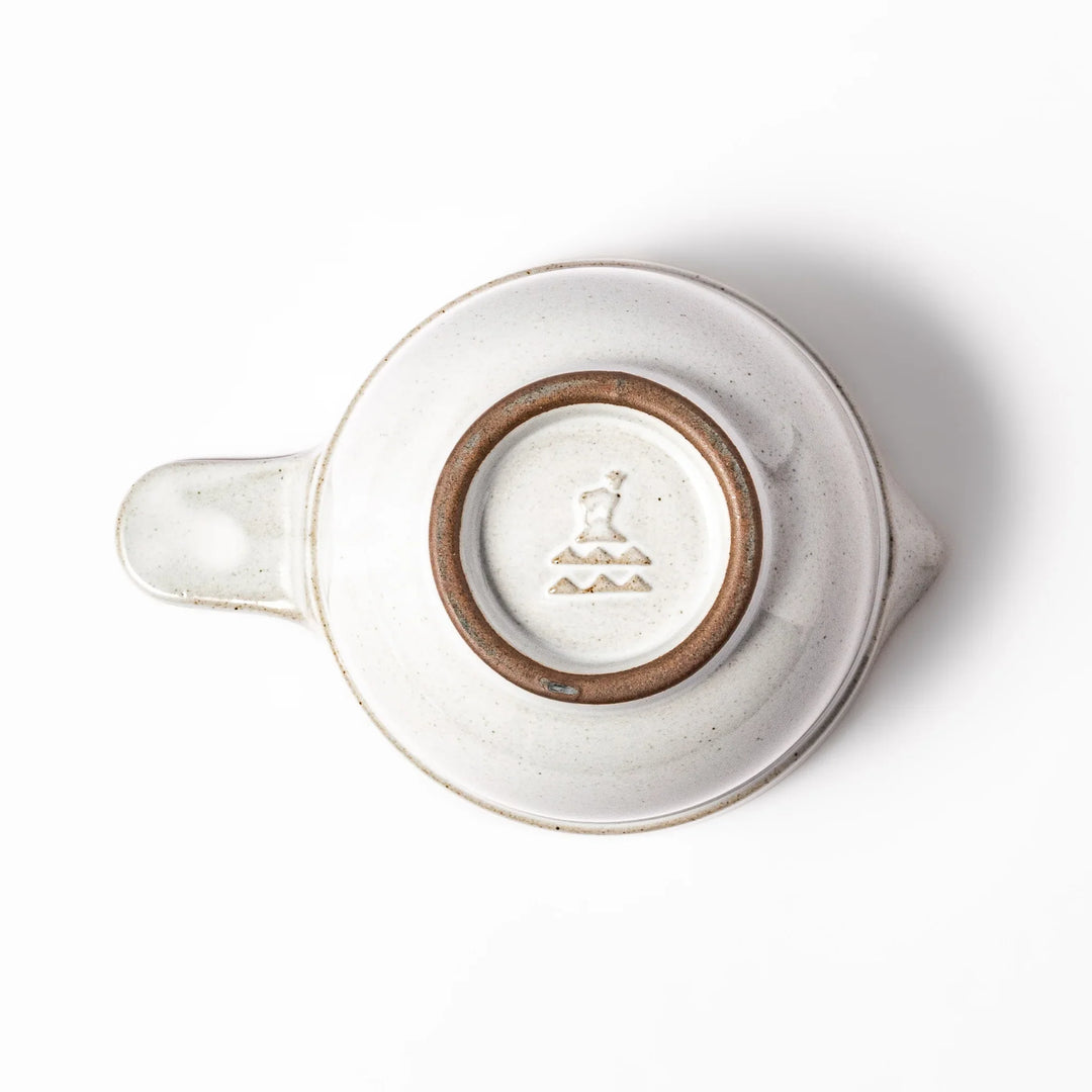 White ceramic natto suribachi bowl with a textured brown interior and side handle, ideal for grinding ingredients or mixing natto with control.