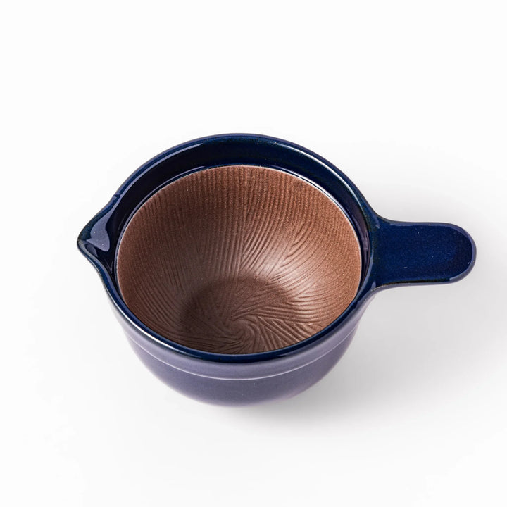Deep blue ceramic natto suribachi bowl with ridged brown interior and side handle, perfect for mixing natto or grinding small ingredients with ease.