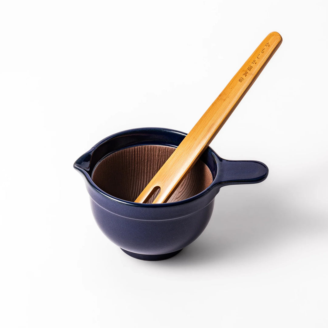 Deep blue ceramic natto suribachi bowl with ridged brown interior and side handle, perfect for mixing natto or grinding small ingredients with ease.