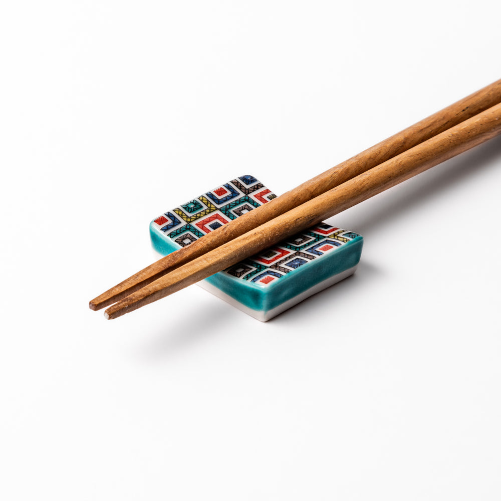 Japanese ceramic chopstick rest with colorful cobblestone mosaic pattern in red, blue, green, yellow, and black, adding elegance to any dining table.