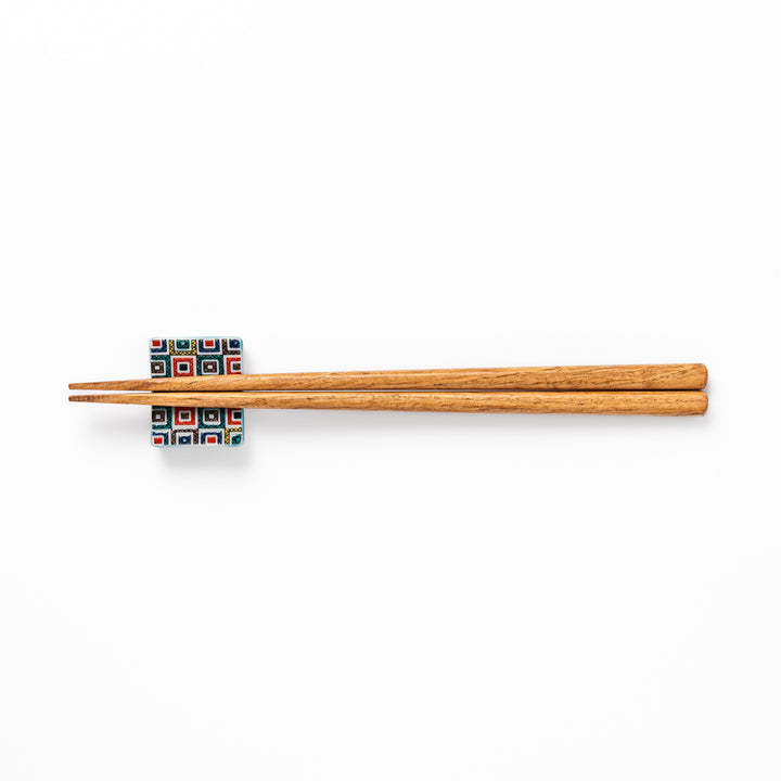 Japanese ceramic chopstick rest with colorful cobblestone mosaic pattern in red, blue, green, yellow, and black, adding elegance to any dining table.