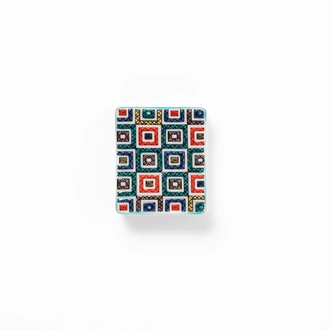 Japanese ceramic chopstick rest with colorful cobblestone mosaic pattern in red, blue, green, yellow, and black, adding elegance to any dining table.