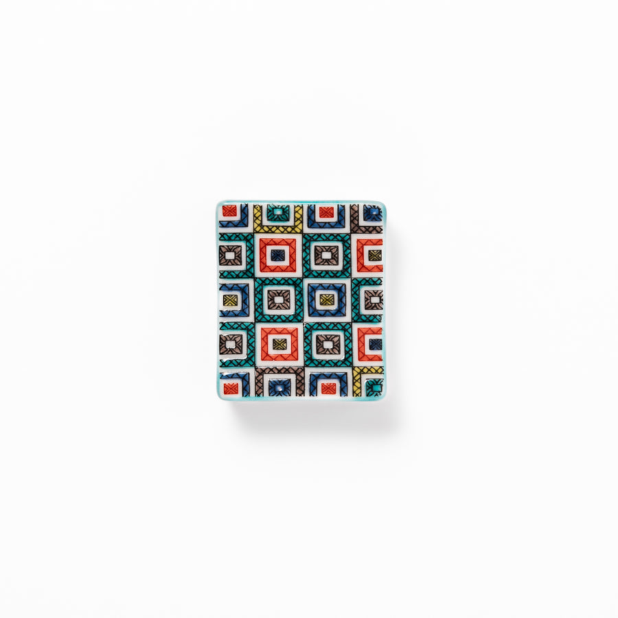 Japanese ceramic chopstick rest with colorful cobblestone mosaic pattern in red, blue, green, yellow, and black, adding elegance to any dining table.