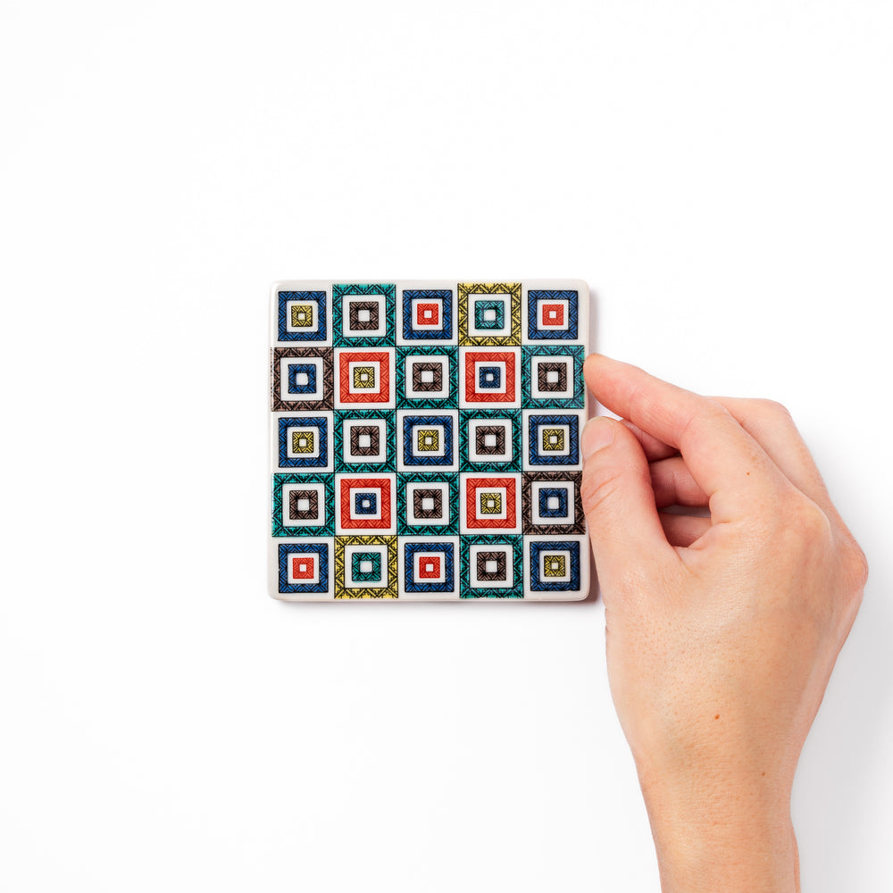 Square Japanese ceramic coaster with colorful cobblestone mosaic pattern in red, blue, green, yellow, and black, ideal for stylish table settings.