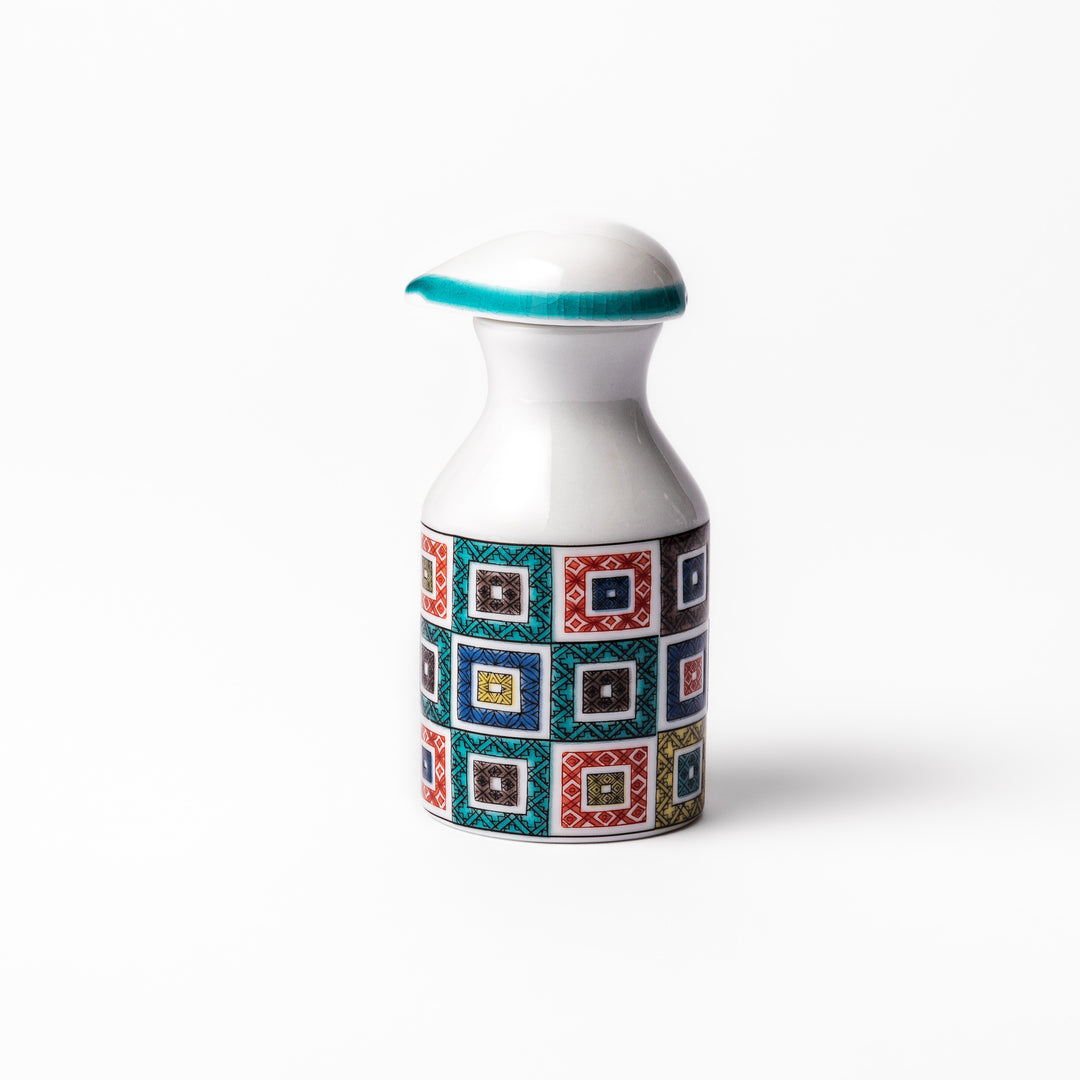 Japanese soy sauce dispenser with colorful cobblestone mosaic pattern in red, green, blue, and yellow, blending tradition with modern design.