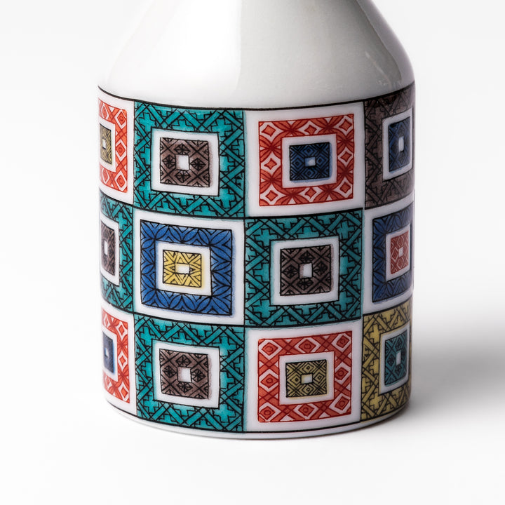 Japanese soy sauce dispenser with colorful cobblestone mosaic pattern in red, green, blue, and yellow, blending tradition with modern design.