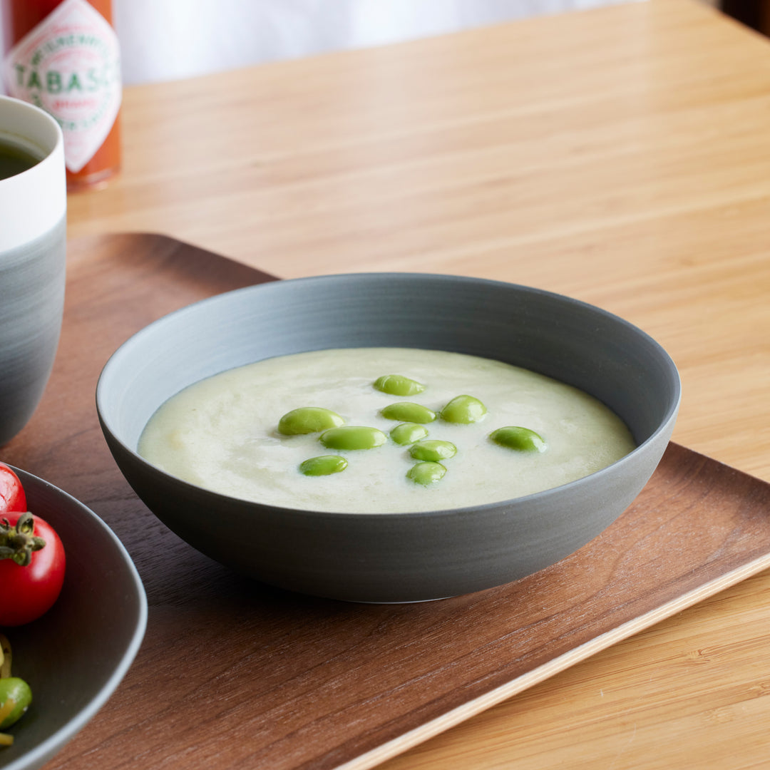 Cozy Japandi Cereal Bowl in matte gray, filled with creamy soup topped with fresh edamame beans for a warm, modern dining touch.