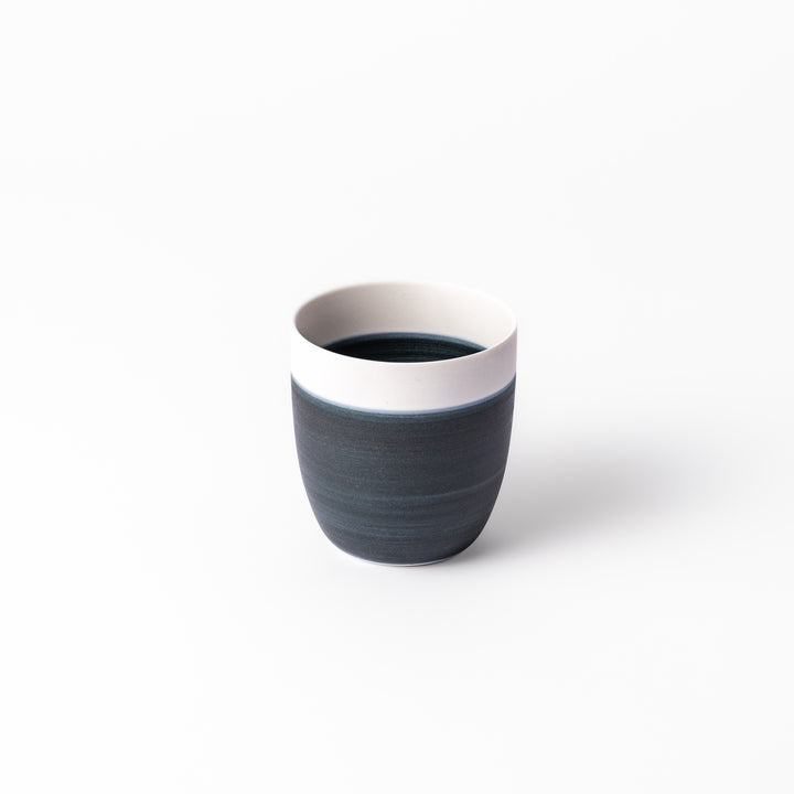 Two-tone ceramic tea cup featuring a soft ivory rim and deep blue base. Perfect for modern, cozy tea moments and Japandi-style settings.
