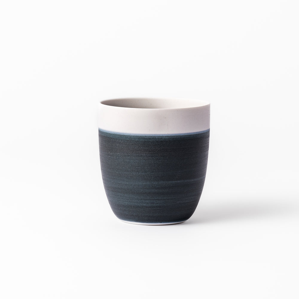 Two-tone ceramic tea cup featuring a soft ivory rim and deep blue base. Perfect for modern, cozy tea moments and Japandi-style settings.