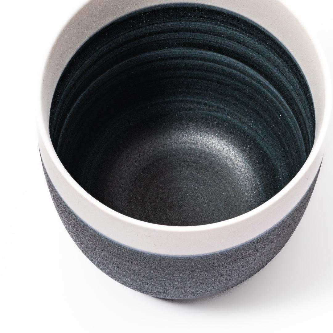 Two-tone ceramic tea cup featuring a soft ivory rim and deep blue base. Perfect for modern, cozy tea moments and Japandi-style settings.