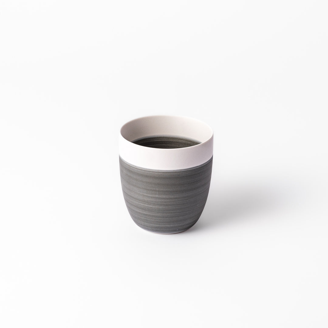 Two-tone ceramic tea cup with a matte ivory rim and earthy gray base. Ideal for serene tea moments and Japandi-inspired tables.