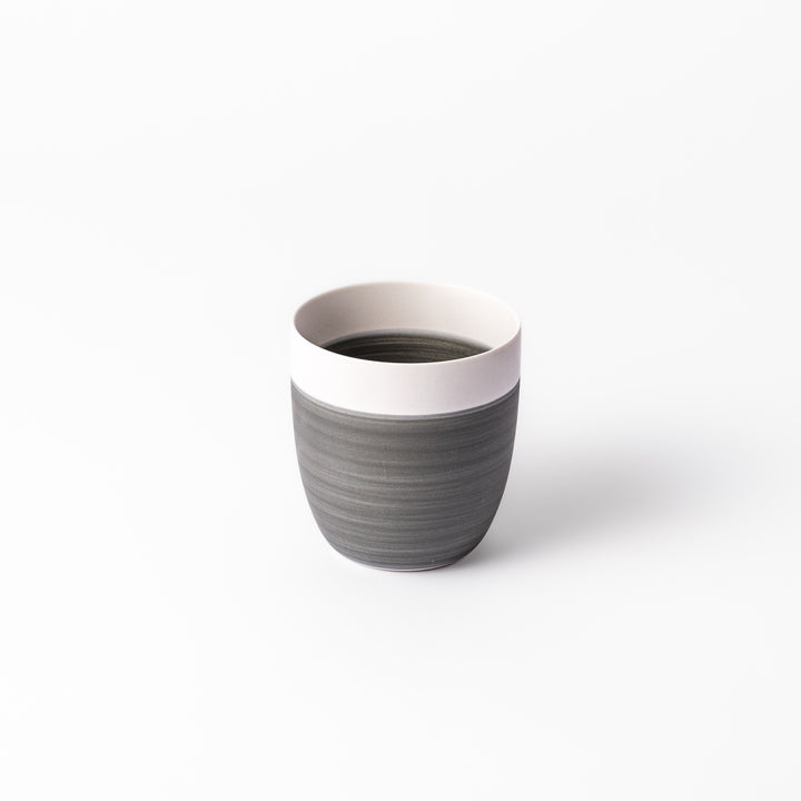 Two-tone ceramic tea cup with a matte ivory rim and earthy gray base. Ideal for serene tea moments and Japandi-inspired tables.