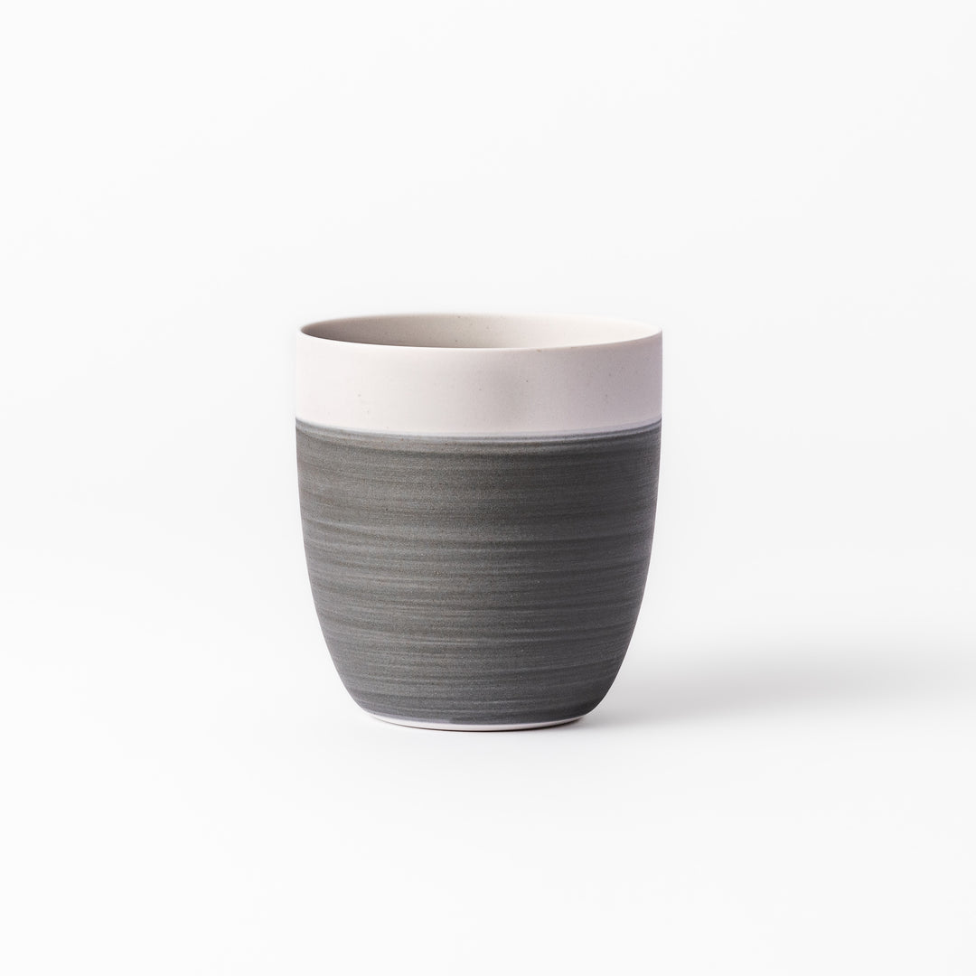Two-tone ceramic tea cup with a matte ivory rim and earthy gray base. Ideal for serene tea moments and Japandi-inspired tables.