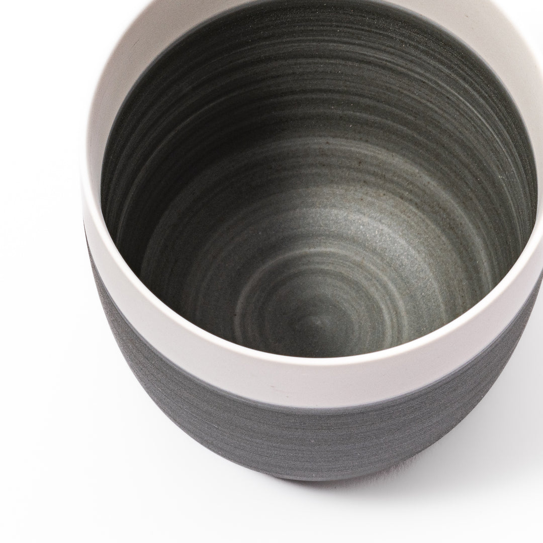 Two-tone ceramic tea cup with a matte ivory rim and earthy gray base. Ideal for serene tea moments and Japandi-inspired tables.