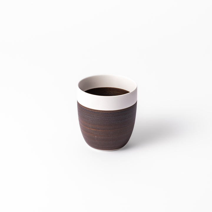 Two-tone ceramic tea cup featuring a smooth matte ivory rim and earthy dark brown base—perfect for warm drinks and everyday comfort.