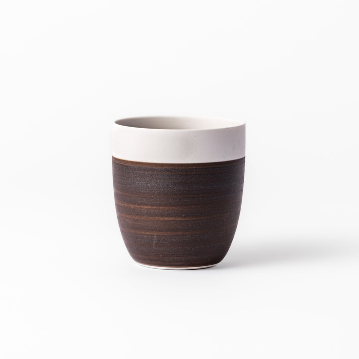 Two-tone ceramic tea cup featuring a smooth matte ivory rim and earthy dark brown base—perfect for warm drinks and everyday comfort.