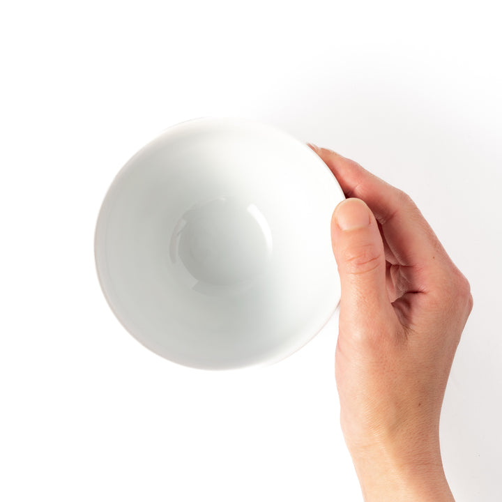 A hand holding a Japanese rice bowl for kids, perfect for everyday meals or small portions.