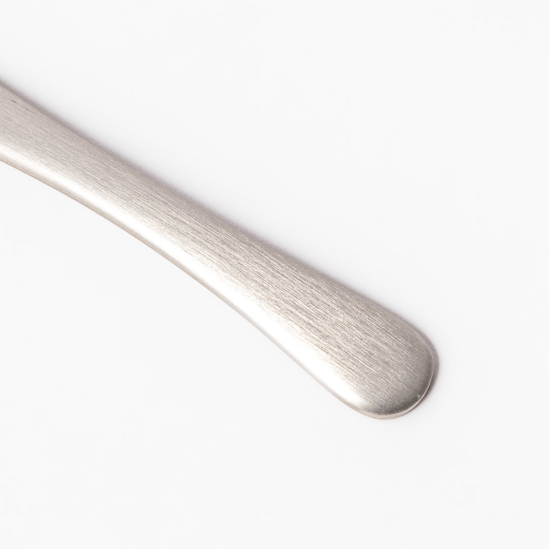 Silver aluminum ice cream spoon with a satin finish and flat edge, engineered for smoothly scooping through even the hardest frozen desserts.