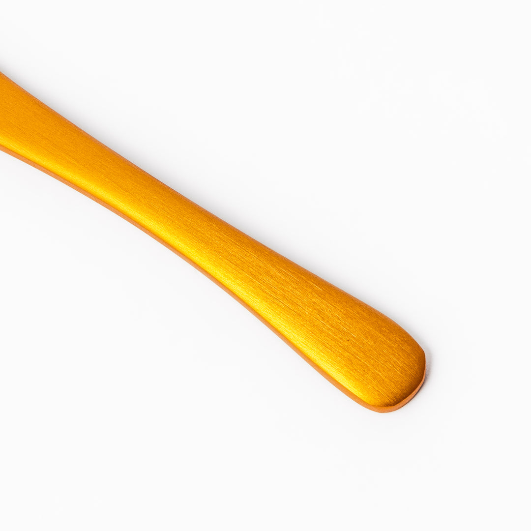 Gold aluminum ice cream spoon with a smooth matte finish and flat scoop edge, designed to glide through hard ice cream with ease and style.
