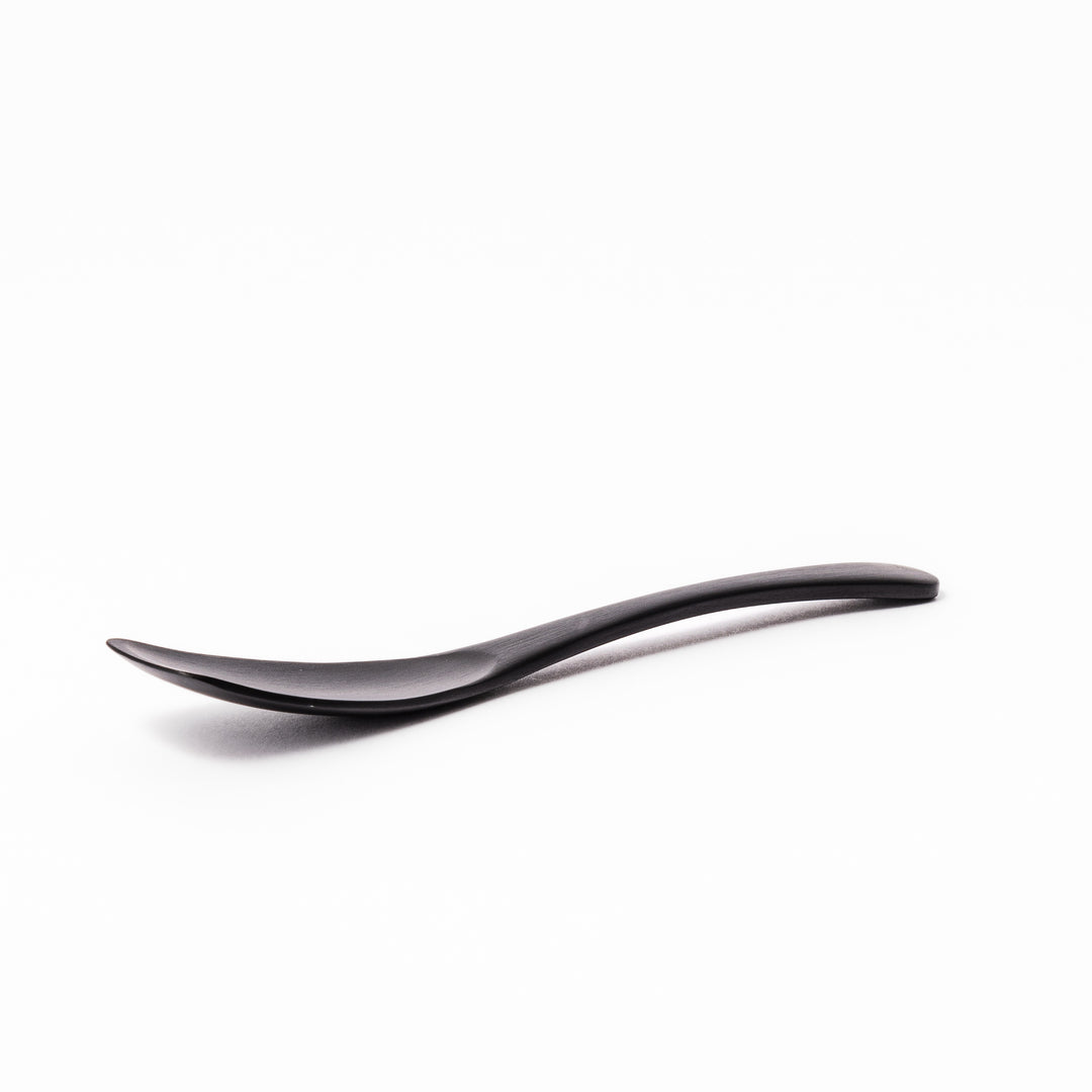 Matte black aluminum ice cream spoon with a flat-edged design, crafted for effortless scooping of firm frozen desserts straight from the freezer.