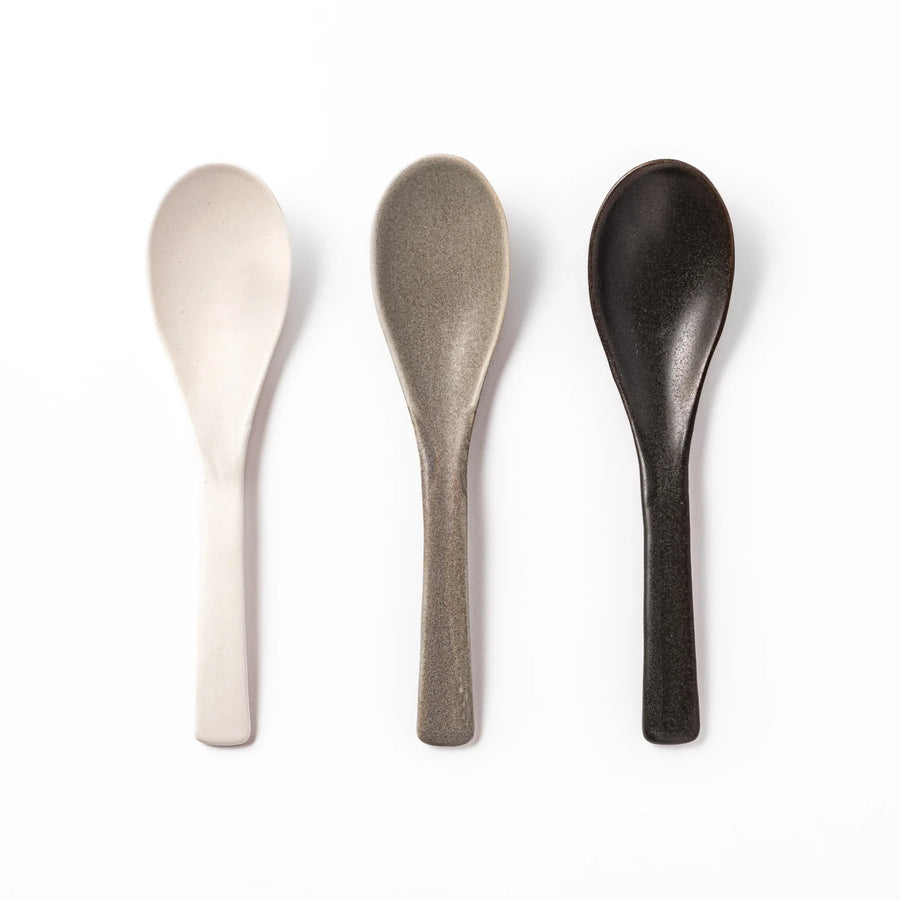 Set of three ceramic spoons in white, gray, and black, each with a gently curved bowl and flat handle, perfect for curry, soup, or side dishes.