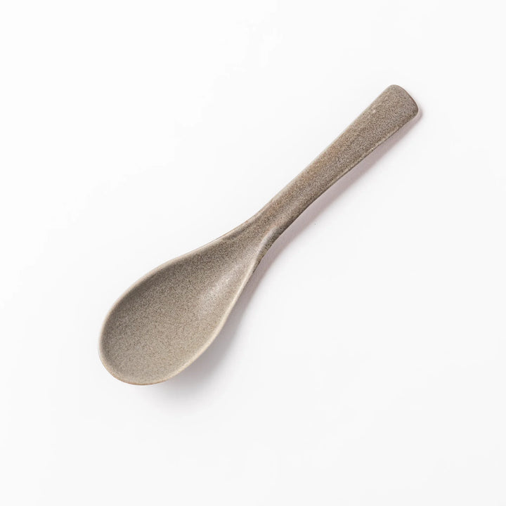 Gray ceramic spoon with a wide, curved bowl and gently angled handle, designed for smooth scooping of soups, stews, and curry dishes.