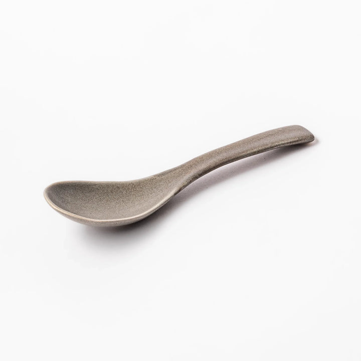 Gray ceramic spoon with a wide, curved bowl and gently angled handle, designed for smooth scooping of soups, stews, and curry dishes.