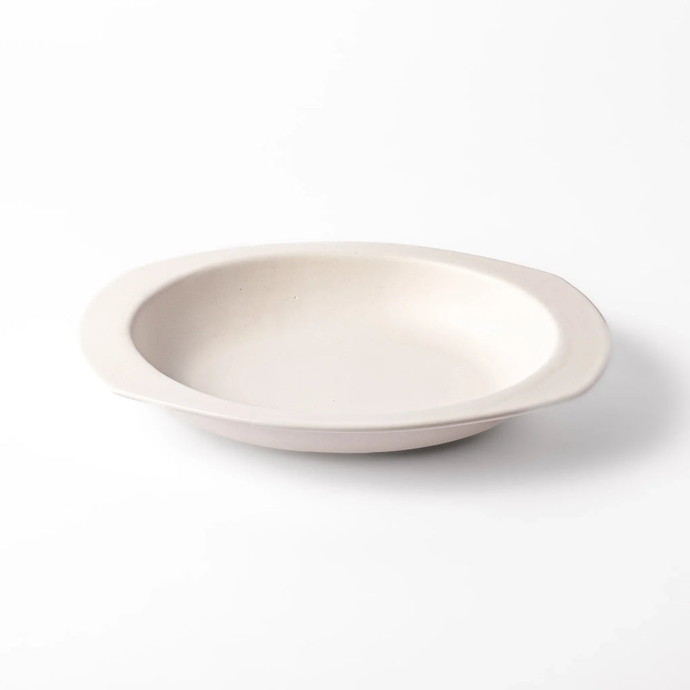 White oval ceramic curry plate with a wide rim and curved sides, designed for smooth scooping and serving of curry, rice, or pasta dishes.