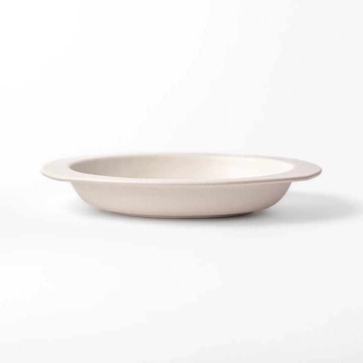 White oval ceramic curry plate with a wide rim and curved sides, designed for smooth scooping and serving of curry, rice, or pasta dishes.