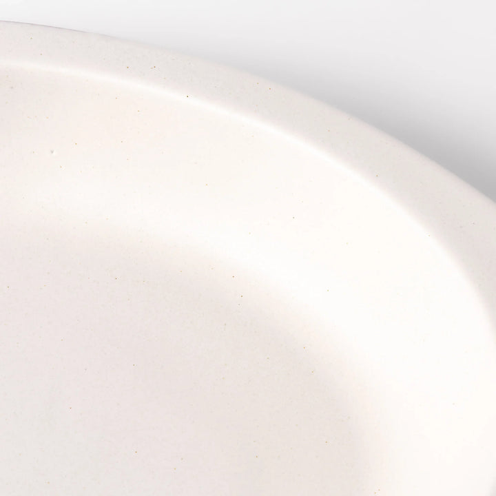 White oval ceramic curry plate with a wide rim and curved sides, designed for smooth scooping and serving of curry, rice, or pasta dishes.