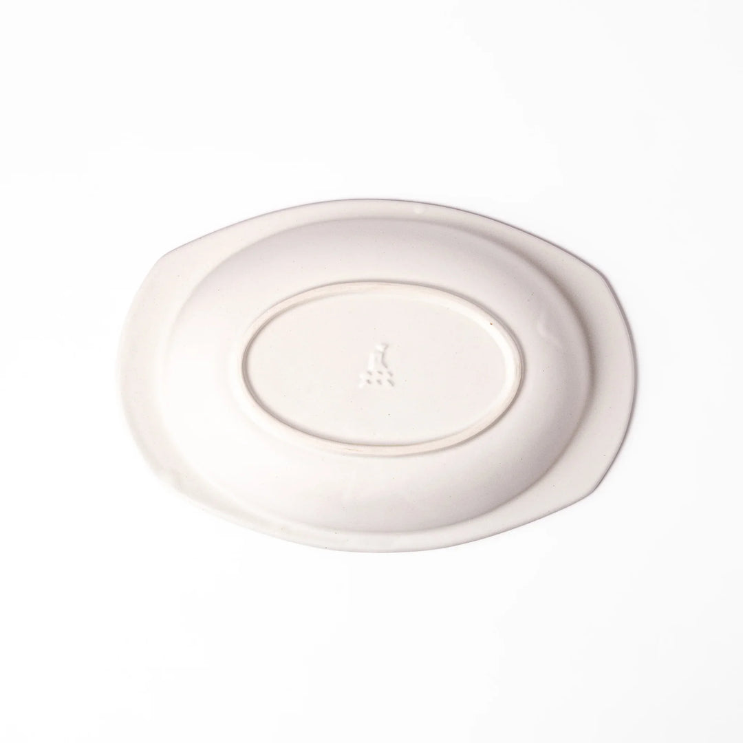 White oval ceramic curry plate with a wide rim and curved sides, designed for smooth scooping and serving of curry, rice, or pasta dishes.