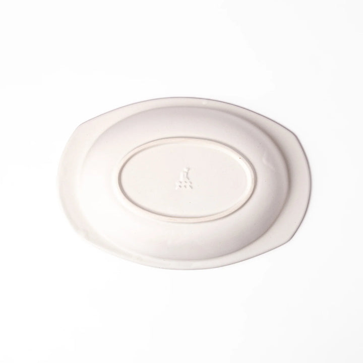 White oval ceramic curry plate with a wide rim and curved sides, designed for smooth scooping and serving of curry, rice, or pasta dishes.