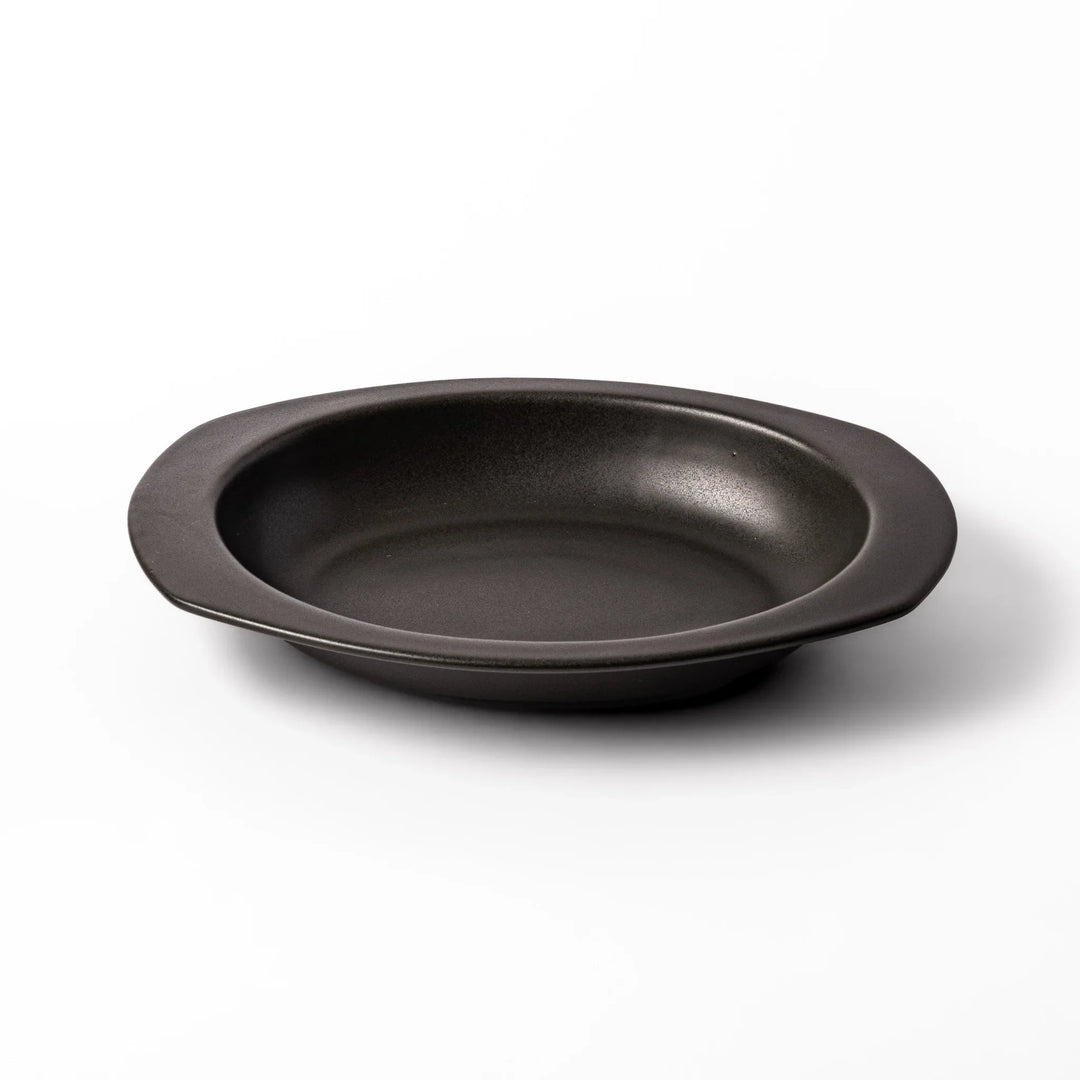 Black oval ceramic curry plate with wide rim and curved edges, designed for effortless scooping and perfect for curry, rice, or pasta dishes.