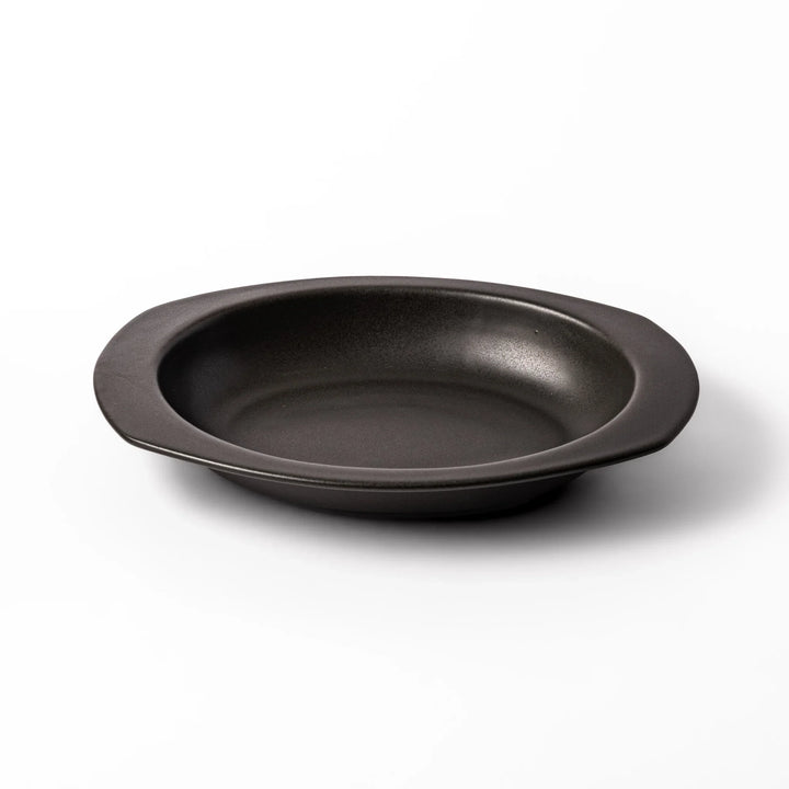 Black oval ceramic curry plate with wide rim and curved edges, designed for effortless scooping and perfect for curry, rice, or pasta dishes.