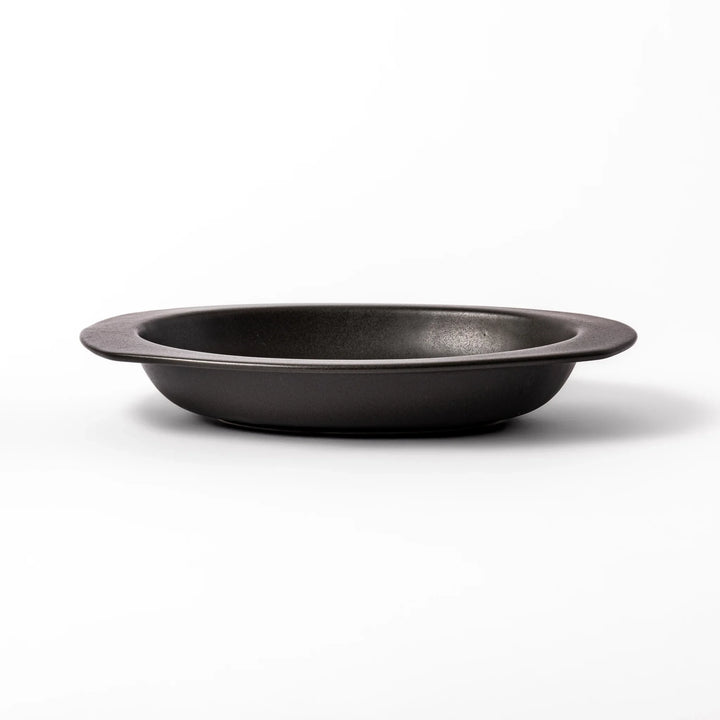 Black oval ceramic curry plate with wide rim and curved edges, designed for effortless scooping and perfect for curry, rice, or pasta dishes.