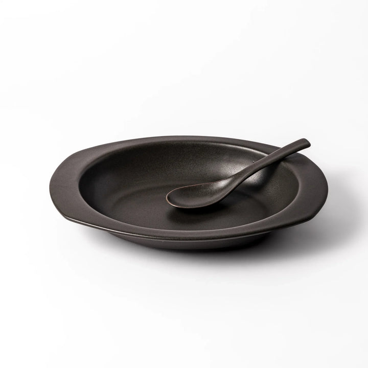 Black oval ceramic curry plate with wide rim and curved edges, designed for effortless scooping and perfect for curry, rice, or pasta dishes.