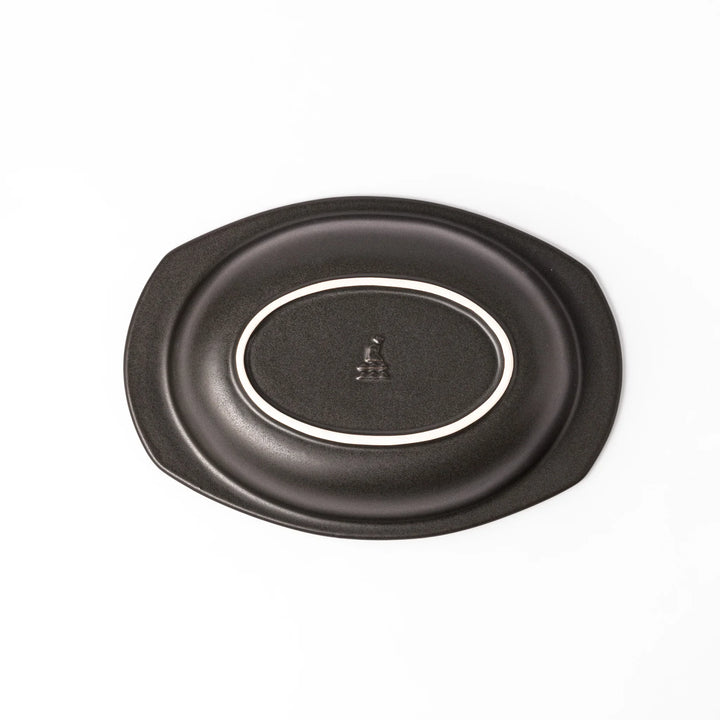 Black oval ceramic curry plate with wide rim and curved edges, designed for effortless scooping and perfect for curry, rice, or pasta dishes.