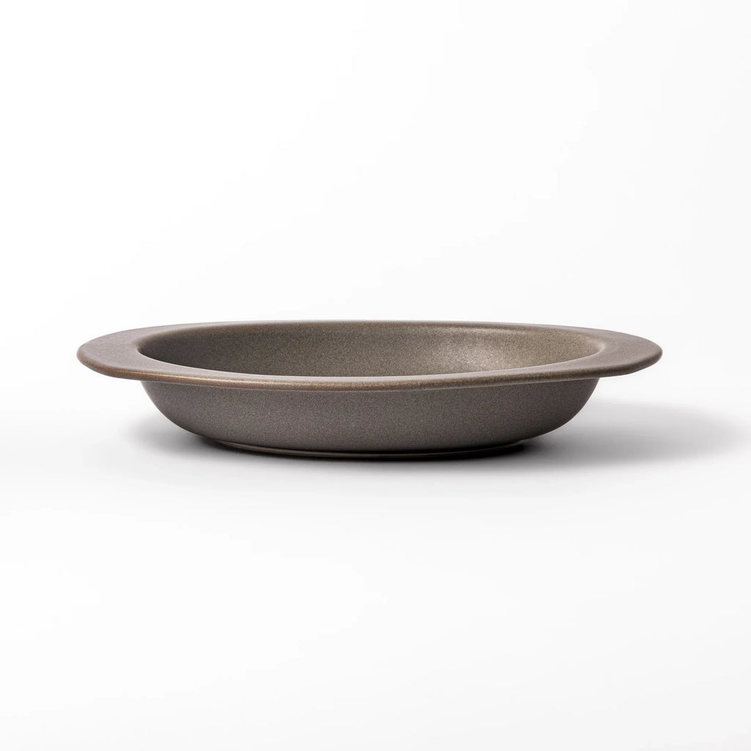 Gray oval ceramic curry plate with gently raised sides and wide rim, designed for easy scooping and serving rice, curry, or stew dishes.