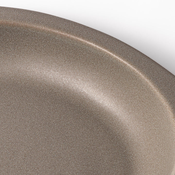 Gray oval ceramic curry plate with gently raised sides and wide rim, designed for easy scooping and serving rice, curry, or stew dishes.