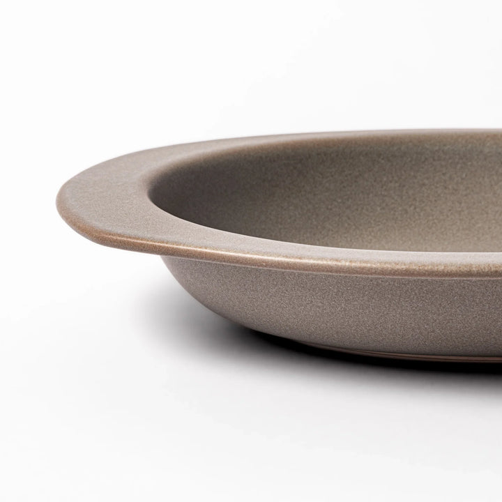 Gray oval ceramic curry plate with gently raised sides and wide rim, designed for easy scooping and serving rice, curry, or stew dishes.